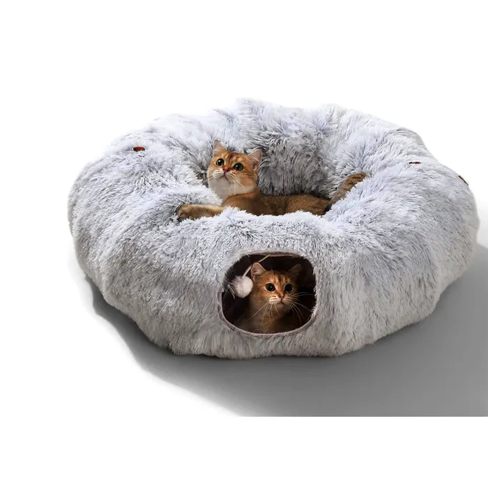 Two orange cats curled in a fluffy gray donut bed